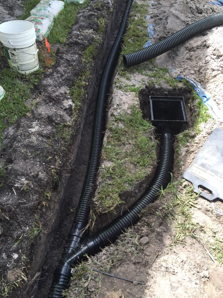 Corrugated drainage pipe installation in a residential yard
